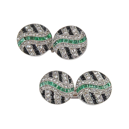 Pair of Art Deco diamond, onyx and emerald cufflinks, c.1925, possibly French, circular panels with a geometric design,